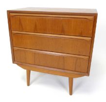 A 1960s Danish teak low chest of three long drawers, having curved integral elongated handles,