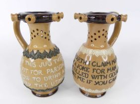 A pair of Doulton Lambeth stoneware puzzle jugs, each with pierced rims and necks, of lower