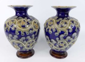 George Tinworth (1843-1913) for Doulton Lambeth - a pair of stoneware baluster form footed vases,