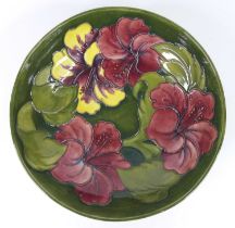 A large early 20th century Moorcroft Hibiscus pattern pottery footed table bowl, underglaze