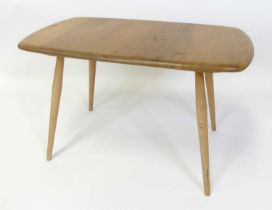 An Ercol blond elm low occasional table, model No. 213, raised on typical turned tapering