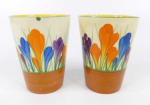 A pair of 1930s Clarice Cliff Crocus pattern pottery beakers, each of cylindrical tapering form,