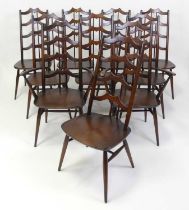 A set of ten Ercol dark elm dining chairs, model 496 and 496A, each with shaped laddered backs,