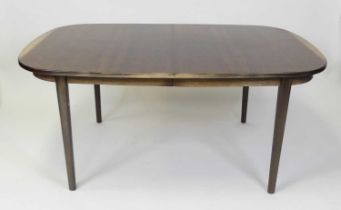 A 1960s Danish rosewood extending dining table, having pull-out action, D-shaped ends, two extra