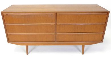 A 1960s Danish teak compact sideboard, having twin flights of three long drawers, each with curved