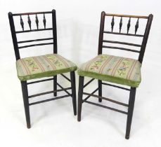 A pair of Aesthetic Movement ebonised oak Sussex chairs, having turned detailed and railed backs,