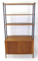 A 1960s Danish teak single modular wall unit, having three open shelves over lower cupboard