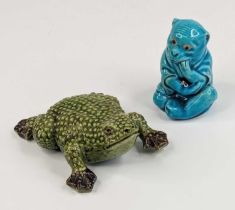 A Burmantofts turquoise glazed 'faience' model of a monkey, shown in seated pose, having later glass