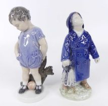A Royal Copenhagen glazed porcelain figure of a standing boy with teddy-bear, printed marks and