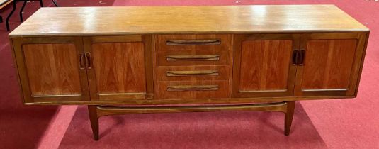 A 1960s G-Plan 'Fresco' teak long sideboard, having four central drawers flanked by twin panelled