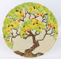 An Art Deco Carltonware 'Acorn Tree' pottery charger, the raised stylised decoration bright colour