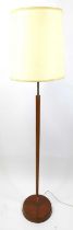 A 1970s teak and rodded metal standard lamp, of plain turned and slightly tapering form, h.134cm (