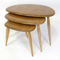 An Ercol blond elm 'Pebble' nest of three occasional tables, model No. 354, each of shaped form