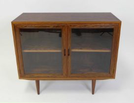 A 1960s Danish rosewood double door glazed bookcase, the twin interior compartments each with single