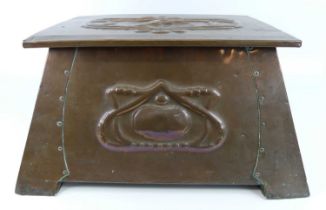 An Art Nouveau embossed copper coal box, the hinged cover over tapering body decorated with stylised
