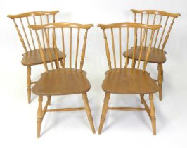 A set of four Ercol blond elm stickback kitchen chairs, model No. 714, raised on turned supports