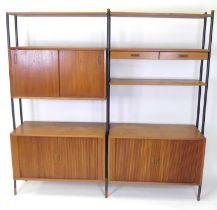 A 1960s Danish teak double modular wall unit, having an arrangement of four shelves, one having