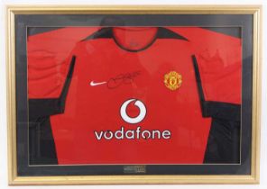 A replica Manchester United Football Club shirt, sponsored by Vodafone, signed David Beckham with
