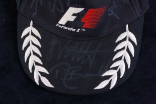 A Formula 1 peaked cap signed by twelve of the drivers, to include Lewis Hamilton, Rubens