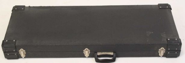 A black vinyl clad guitar / keyboard travel case, having hardened plastic corners and faux fur lined