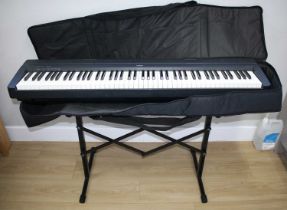 A Yamaha P-35 digital piano, with stand, pedal and a pair Devine Pro 2000 headphones.