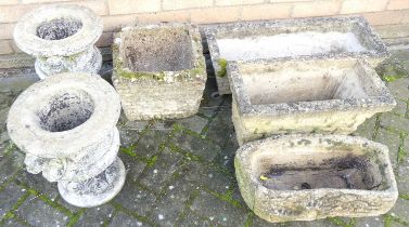 A pair of reconstituted stone squat pedestal urn planters; together with four further sundry