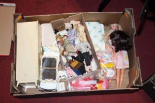A tray containing 3 Sindy dolls, Sindy furniture and clothes and porcelain dolls Dolls are in good