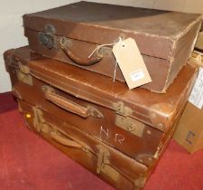 Three various vintage faux leather suitcases, the largest width 59cm