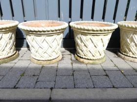 A pair of cream painted reconstituted stone garden planters, each with ropetwist edge and lattice