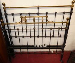 A Victorian wrought iron and brass three-quarter size bedstead, having iron side rails