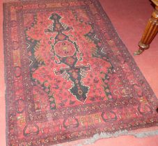 A Persian woollen red ground Shiraz rug, with flatweave ends, 198 x 128cm
