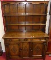 A contemporary joined oak dresser, in the 18th century taste, having two-tier open panelled back