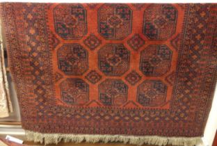 A Persian woollen red ground Bokhara rug, having flatweave ends, 280 x 200cm
