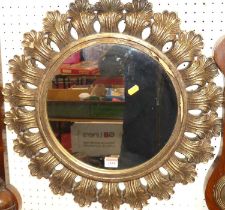 A contemporary circular wall mirror, with repeating leaf decorated surround, dia.52cm