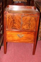 An early 19th century mahogany round cornered night commode, having twin cupboard doors and single
