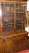An early 19th century mahogany secretaire bookcase, having twin door glazed upper section, three