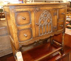 A small Ipswich joined oak side cupboard, having Gothic style arched inset central door, with two
