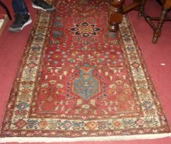 A Persian Star Ushak red ground hall rug, 230 x 108cm