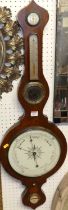 An early 19th century rosewood onion top four dial wheel barometer, the lower scale signed Warranted