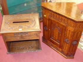 A relief carved oak table top parcel box, with hinged slopefront top and cut-out compartment,
