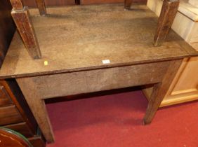 A late 19th century oak hinge top clerk's desk, raised on square slightly tapering block supports,