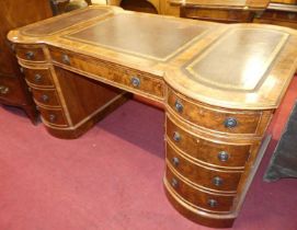 A figured walnut and gilt tooled tan leather inset twin pedestal partner's desk, the frieze