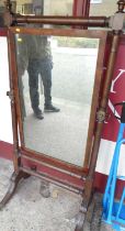 A William IV mahogany cheval mirror, having square cut and turned columns, with urn shaped