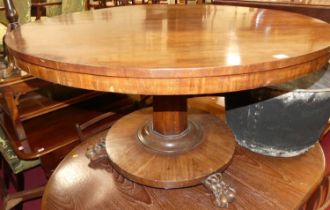 An early Victorian mahogany circular tilt-top pedestal breakfast table, raised on octagonal