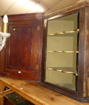 An early 19th century provincial oak single door hanging corner cupboard; together with an oak