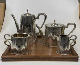 A silver plated four-piece tea and coffee service; together with a carved oak serving tray; and four