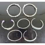 Assorted silver and white metal bangles, to include amethyst and turquoise set examples (7)