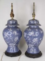 A pair of Chinese table lamps, each in the form of a baluster jar and cover, on hardwood stands, h.