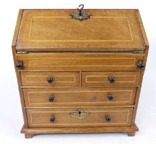 A Victorian mahogany and boxwood strung miniature apprentice bureau, h.24cm