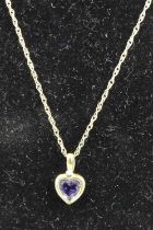 A modern 9ct gold finelink neck chain with amethyst and diamond point set pendant, gross weight 1.